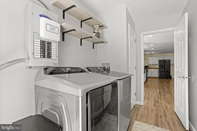 a view of a kitchen area with furniture and wooden floor