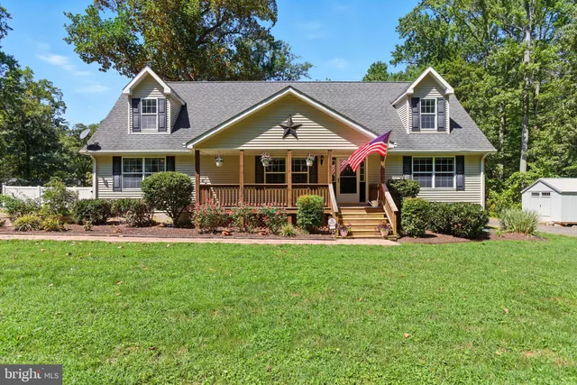 a front view of a house with swimming pool and porch