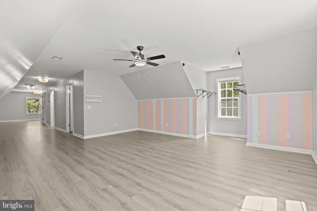 a view of a room with a window and wooden floor