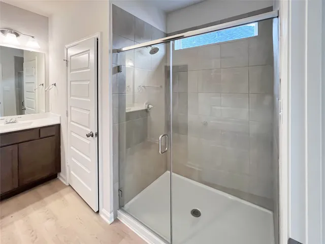 a bathroom with a glass shower door