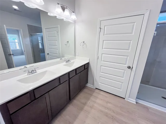 a bathroom with a double vanity sink a and mirror