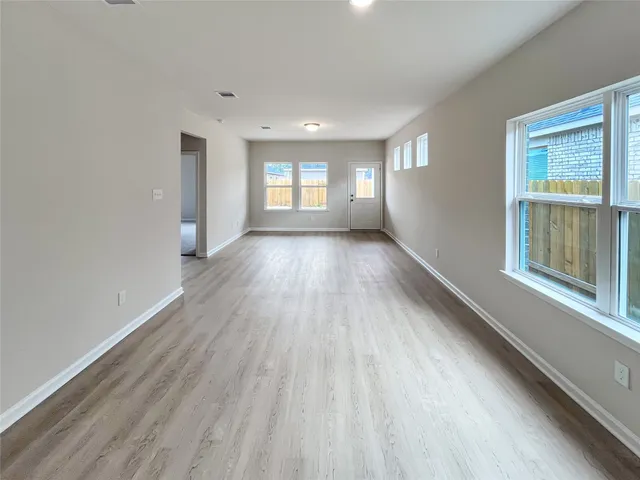 a view of a room with wooden floor and window