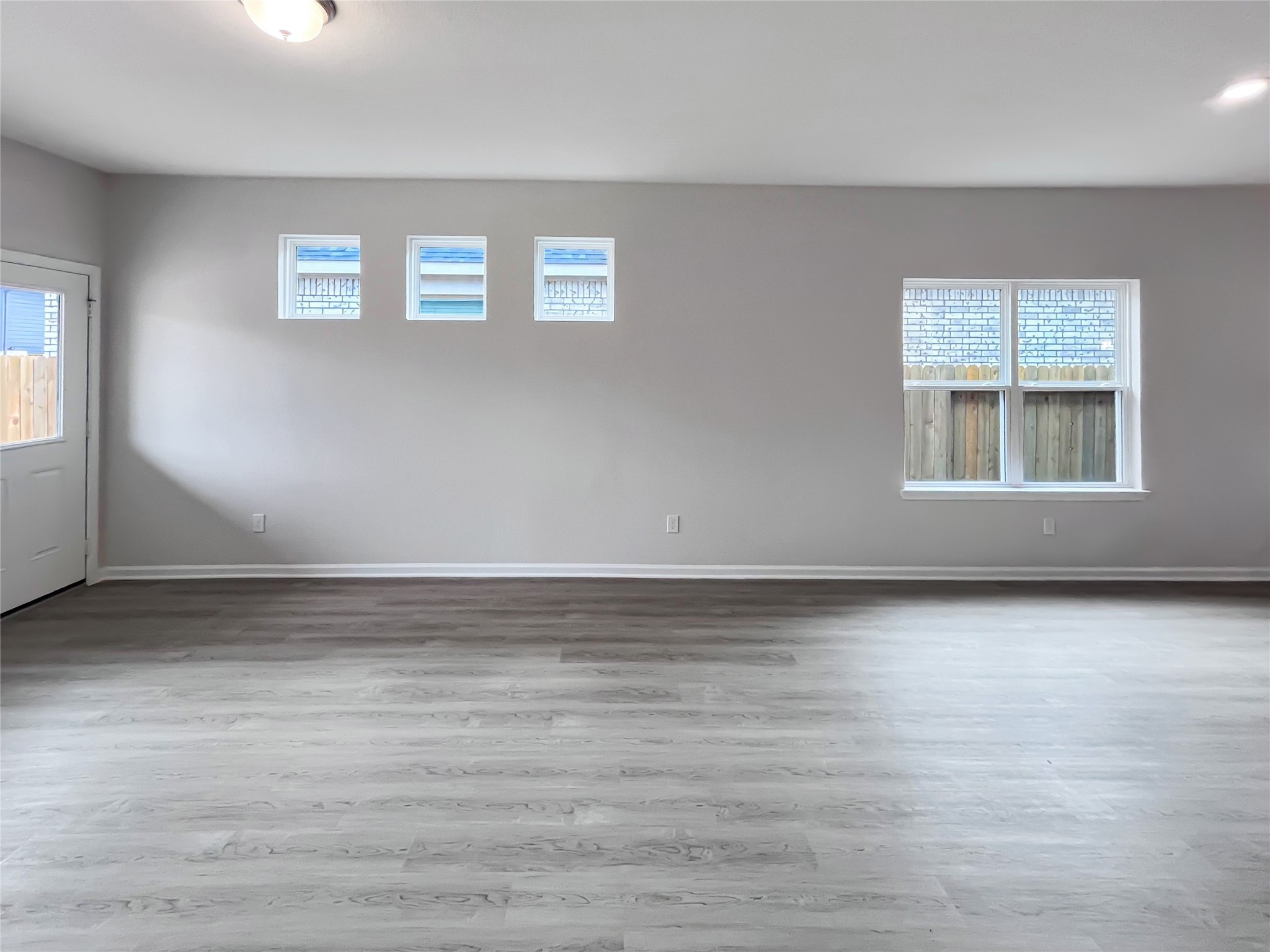321 Stone Placa Trail Pattison, TX 77423 - Photo 9 of 19 a view of an empty room with wooden floor and a window