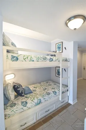 a view of a bedroom with a bed and lamp