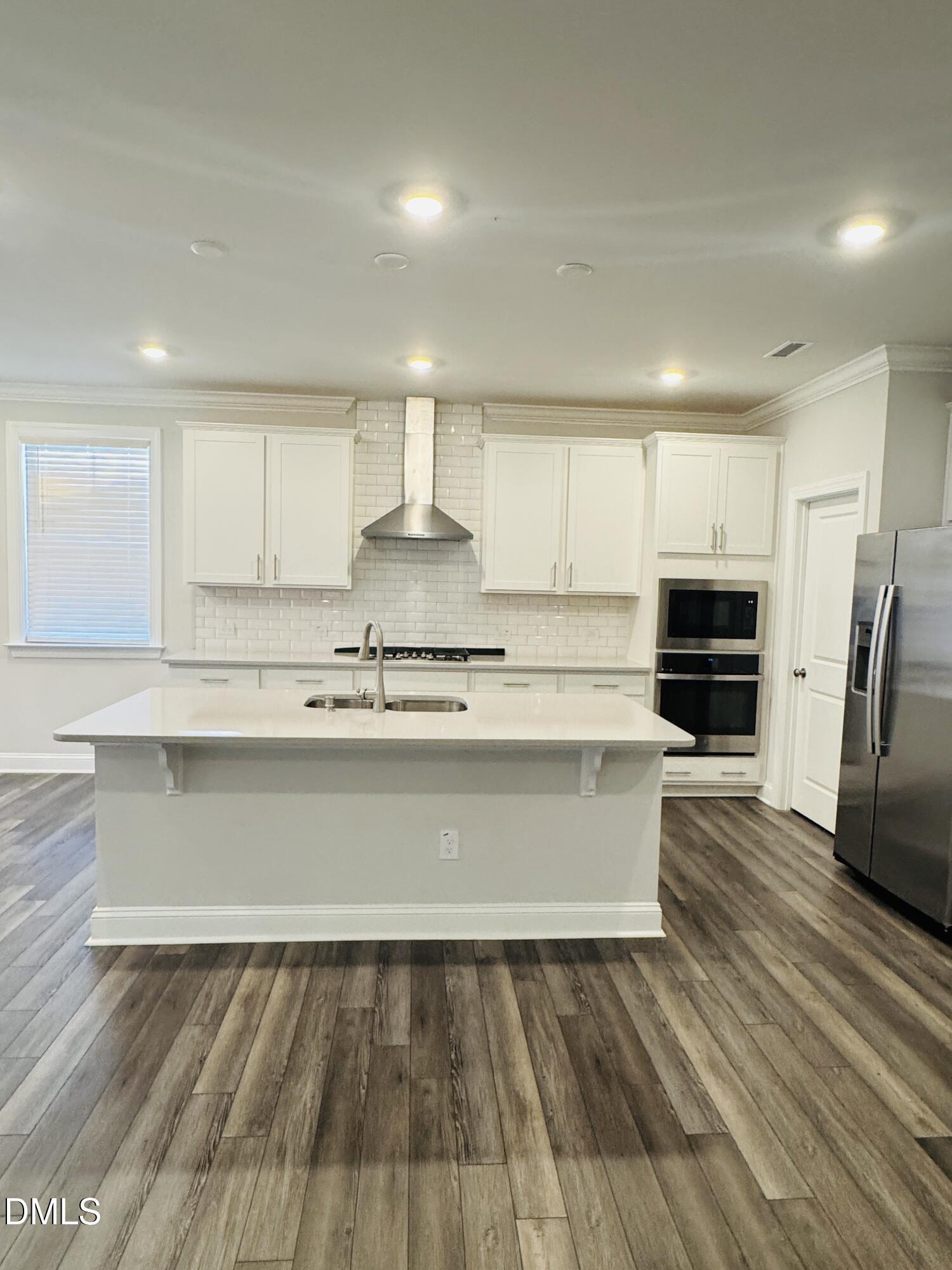 292 Edge Of Auburn Boulevard Raleigh, NC 27610 - Photo 15 of 38 a kitchen with a refrigerator and a stove top oven