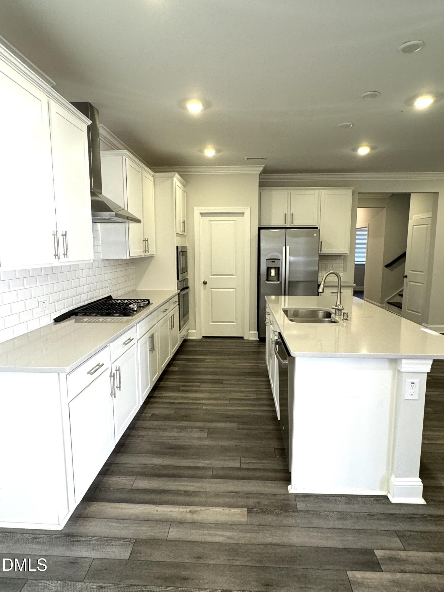 292 Edge Of Auburn Boulevard Raleigh, NC 27610 - Photo 20 of 38 a large kitchen with kitchen island a sink a counter top space stainless steel appliances and a window