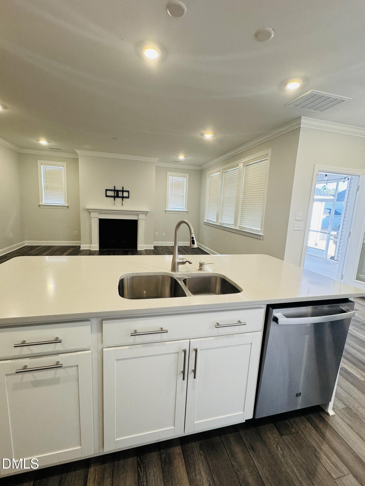 292 Edge Of Auburn Boulevard Raleigh, NC 27610 - Photo 21 of 38 a kitchen with cabinets a sink and dishwasher