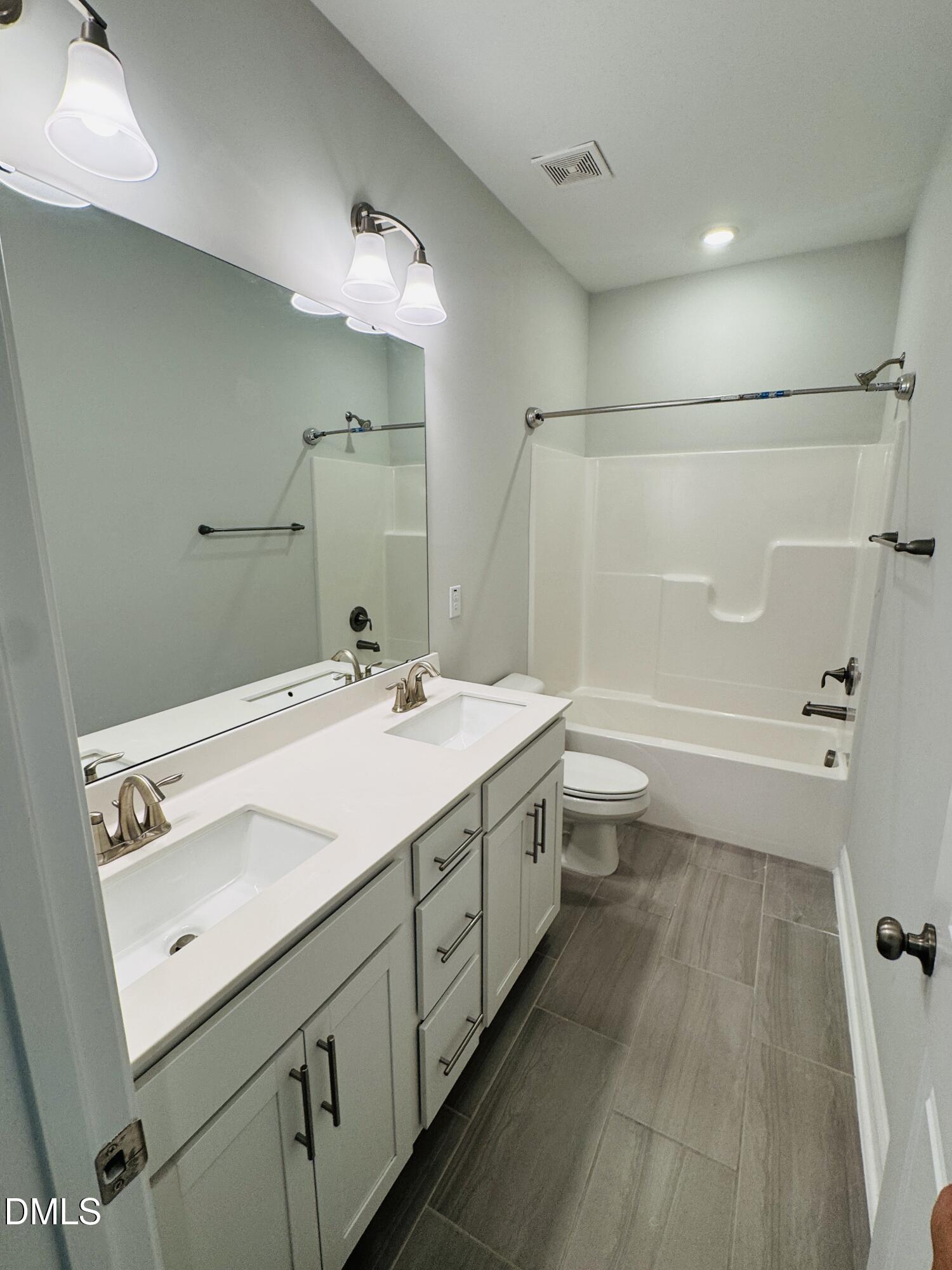 292 Edge Of Auburn Boulevard Raleigh, NC 27610 - Photo 30 of 38 a bathroom with a sink a toilet and shower