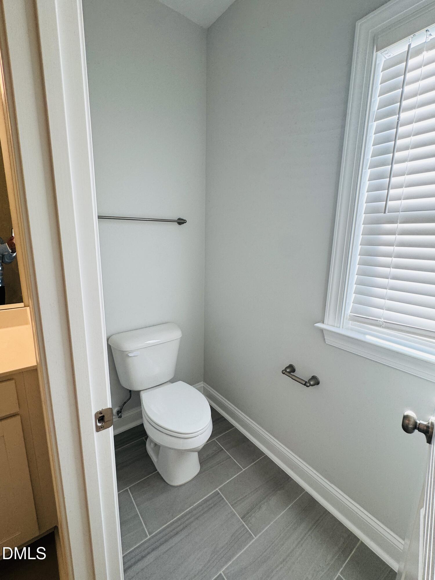 292 Edge Of Auburn Boulevard Raleigh, NC 27610 - Photo 33 of 38 a white toilet sitting next to a small window
