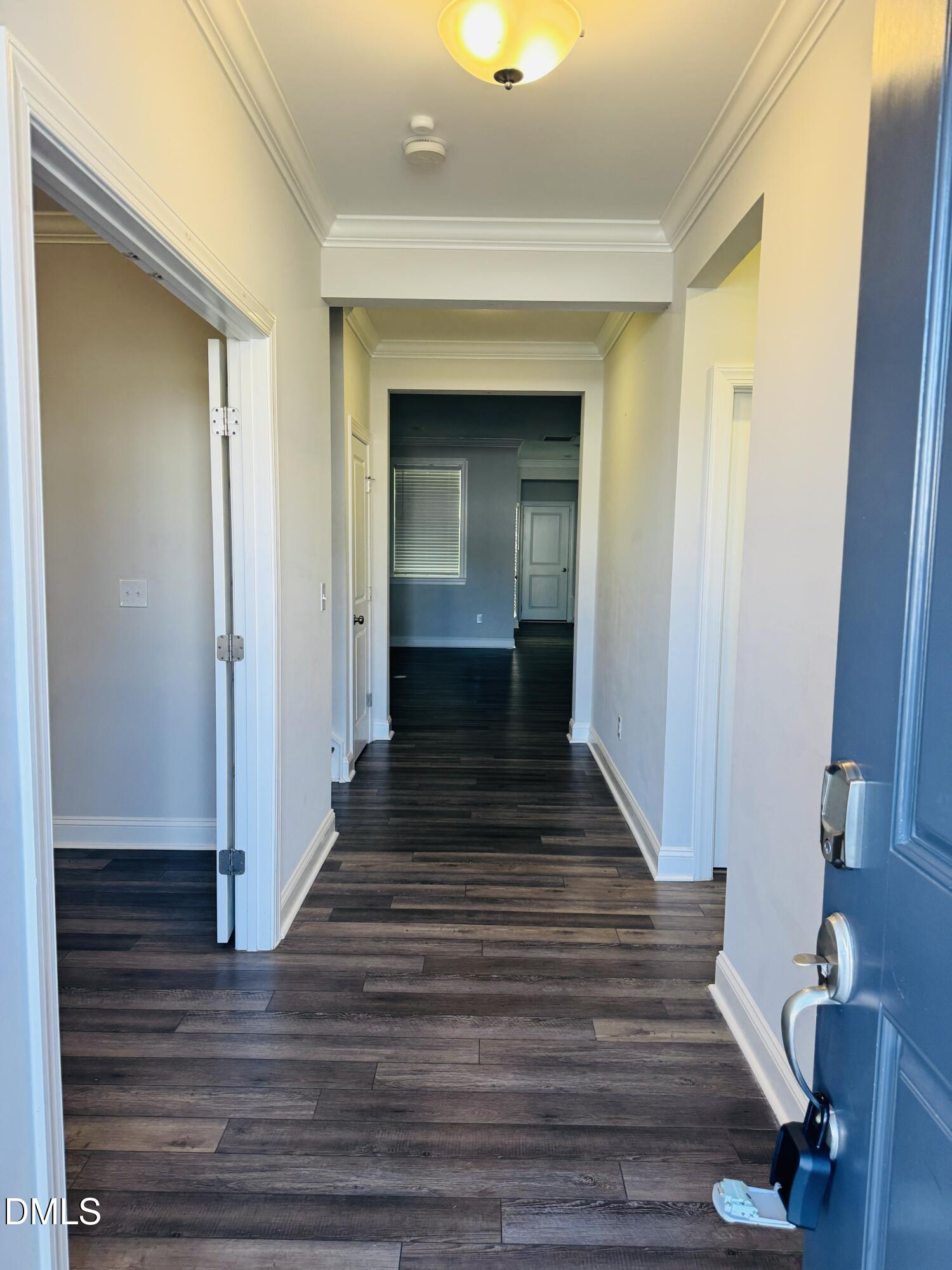 292 Edge Of Auburn Boulevard Raleigh, NC 27610 - Photo 4 of 38 a view of a hallway with wooden floor and staircase