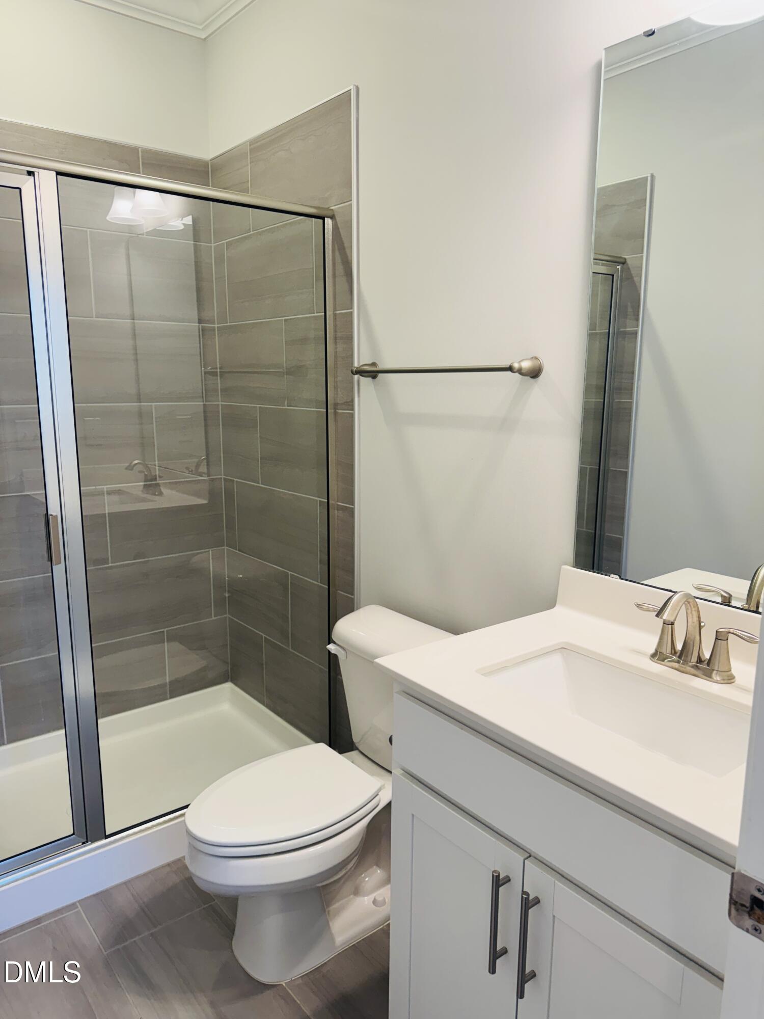 292 Edge Of Auburn Boulevard Raleigh, NC 27610 - Photo 10 of 38 a bathroom with a sink a toilet and shower