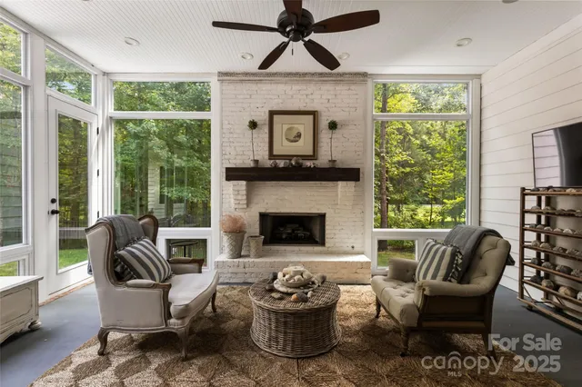 a living room with furniture a window and a fireplace