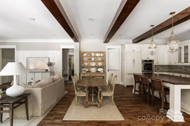 a very nice looking dining room with kitchen island a table and chairs in it