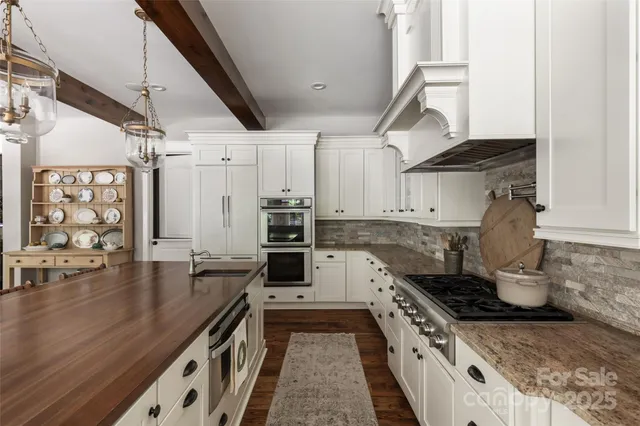 a kitchen with stainless steel appliances granite countertop a stove and a sink