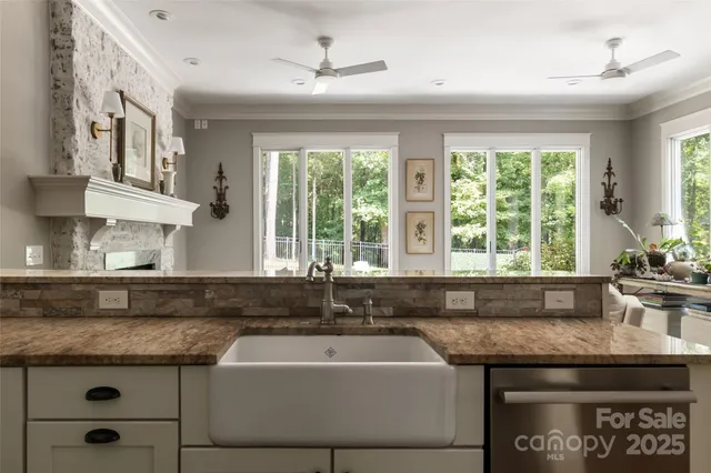 a kitchen with granite countertop a sink and a window