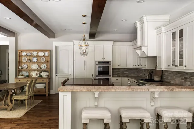 a kitchen with stainless steel appliances granite countertop a sink and cabinets