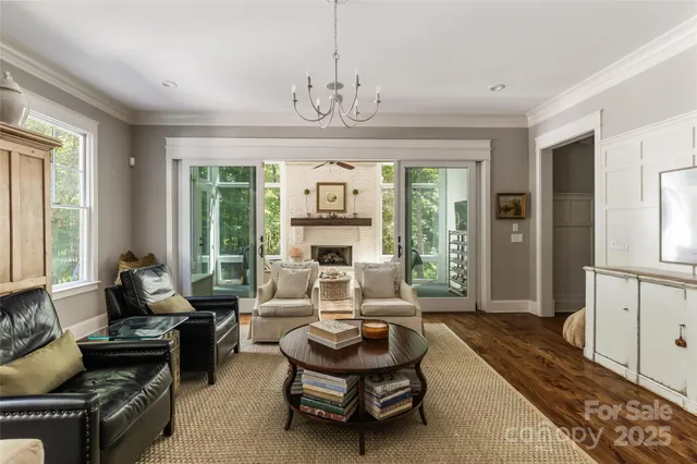 a living room with furniture and a chandelier