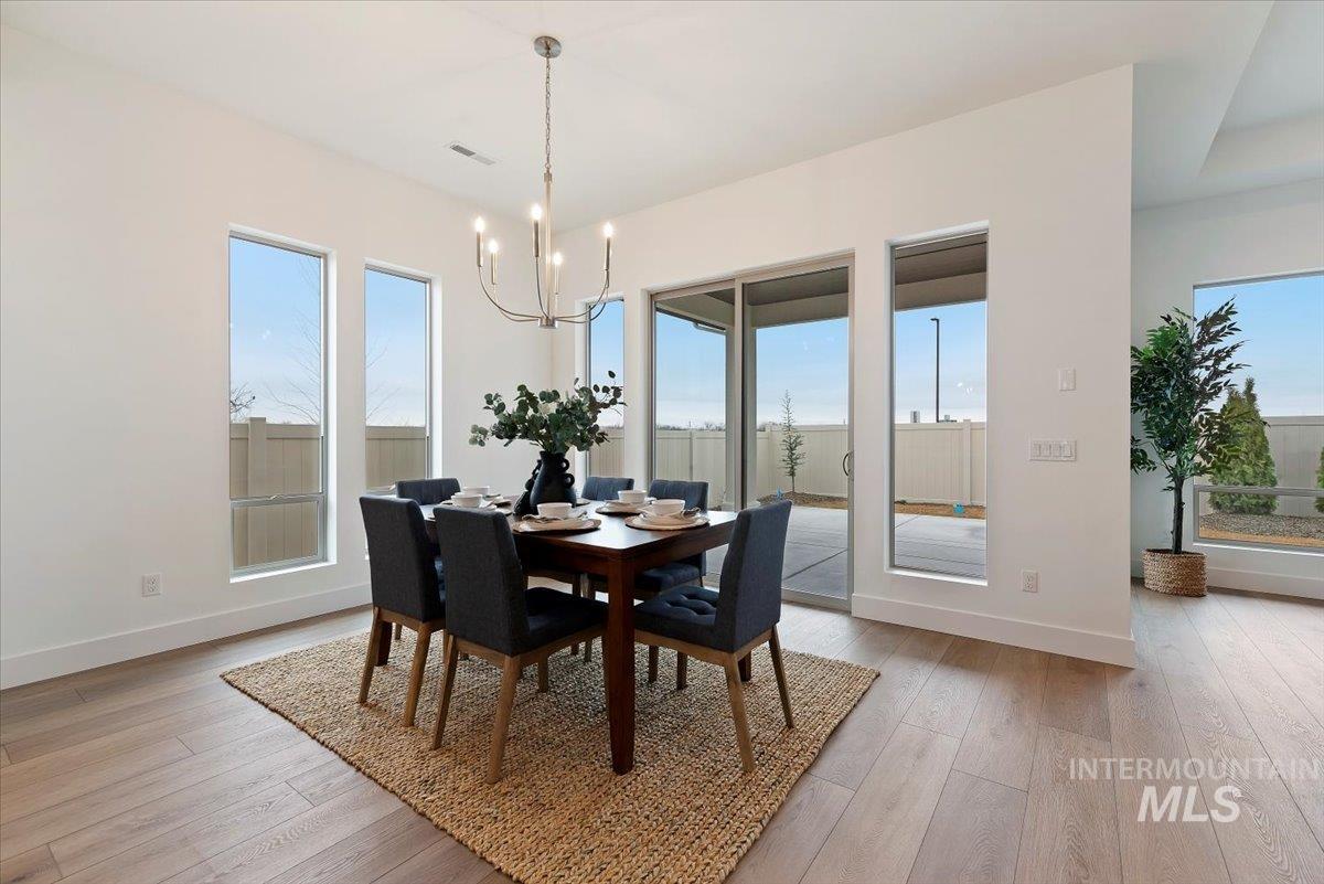 1297 Chena Street Middleton, ID 83644 - Photo 15 of 38 Dining space featuring light wood-type flooring and hanging lights