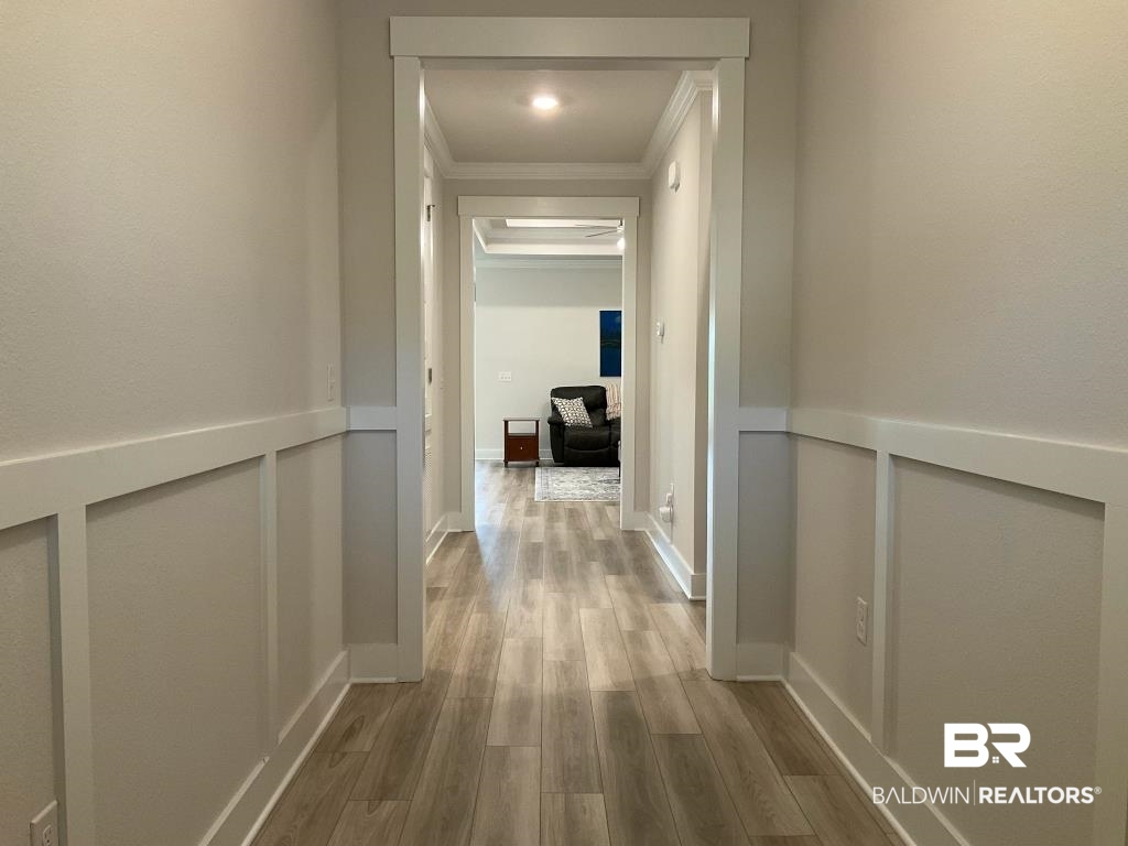 1093 Pheasant Circle Foley, AL 36535 - Photo 4 of 25 Hallway featuring light wood-style floors and crown molding