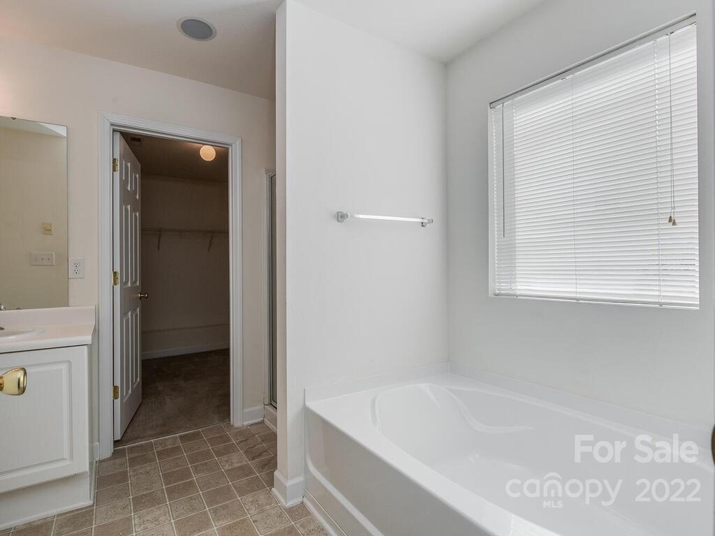 3036 Proverbs Court Monroe, NC 28110 - Photo 13 of 18 a bathroom with a bathtub and a shower