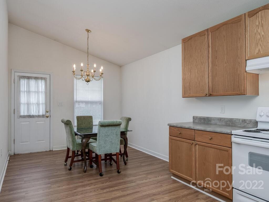 3036 Proverbs Court Monroe, NC 28110 - Photo 7 of 18 a view of a dining room with furniture window and wooden floor