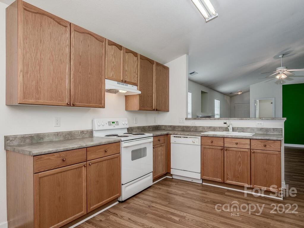 3036 Proverbs Court Monroe, NC 28110 - Photo 8 of 18 a kitchen with granite countertop stainless steel appliances sink and cabinets