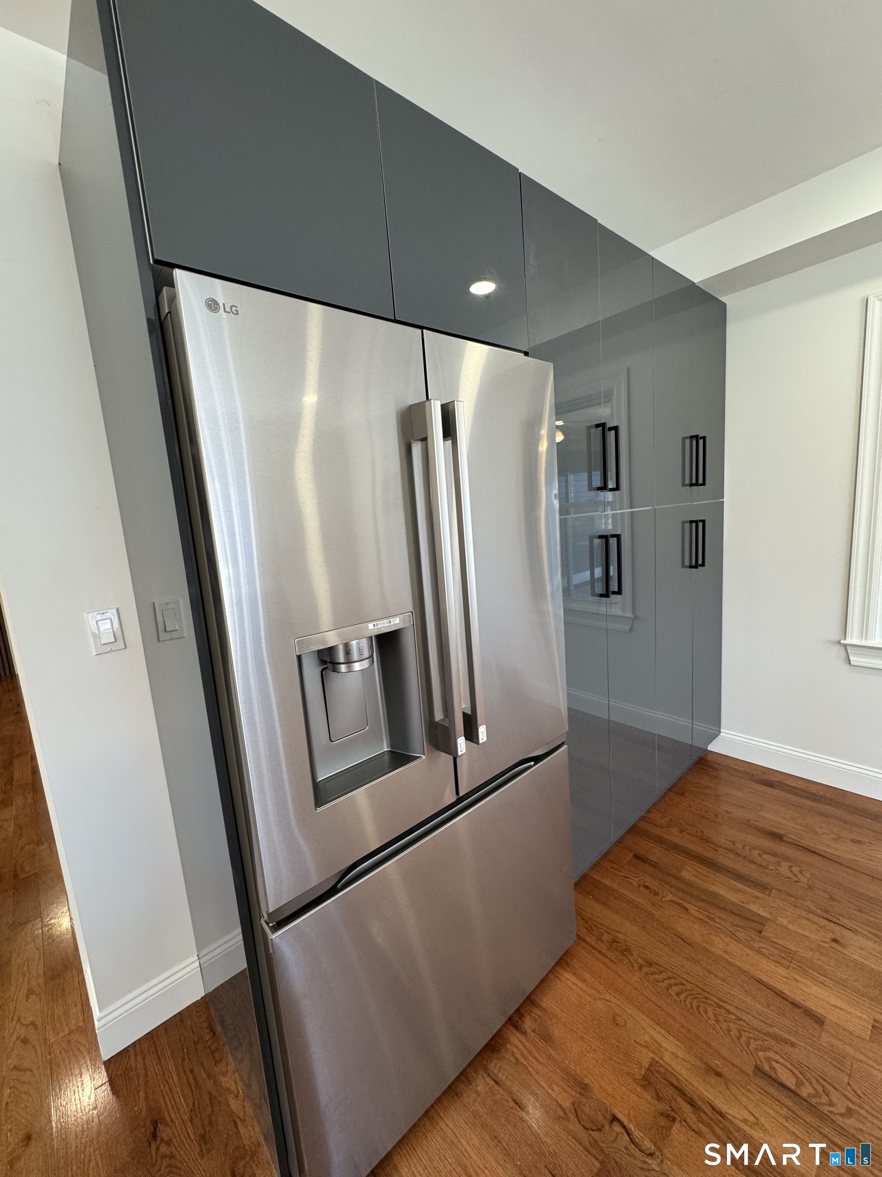 243 Long Hill Road Andover, CT 06232 - Photo 8 of 31 a view of a refrigerator in kitchen and wooden floor