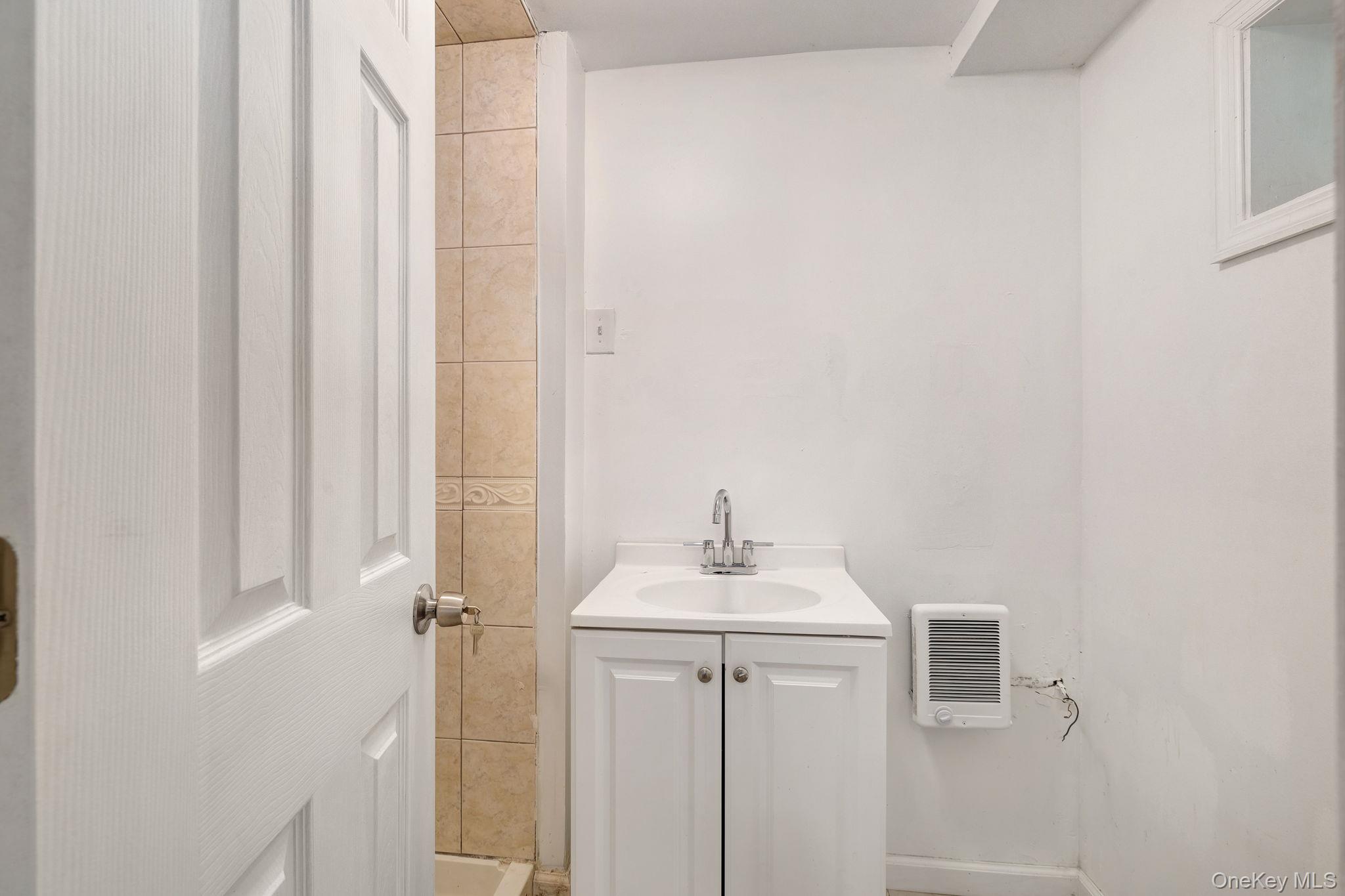 1463 Briscoe Road Swan Lake, NY 12783 - Photo 15 of 21 Bathroom featuring vanity and heating unit