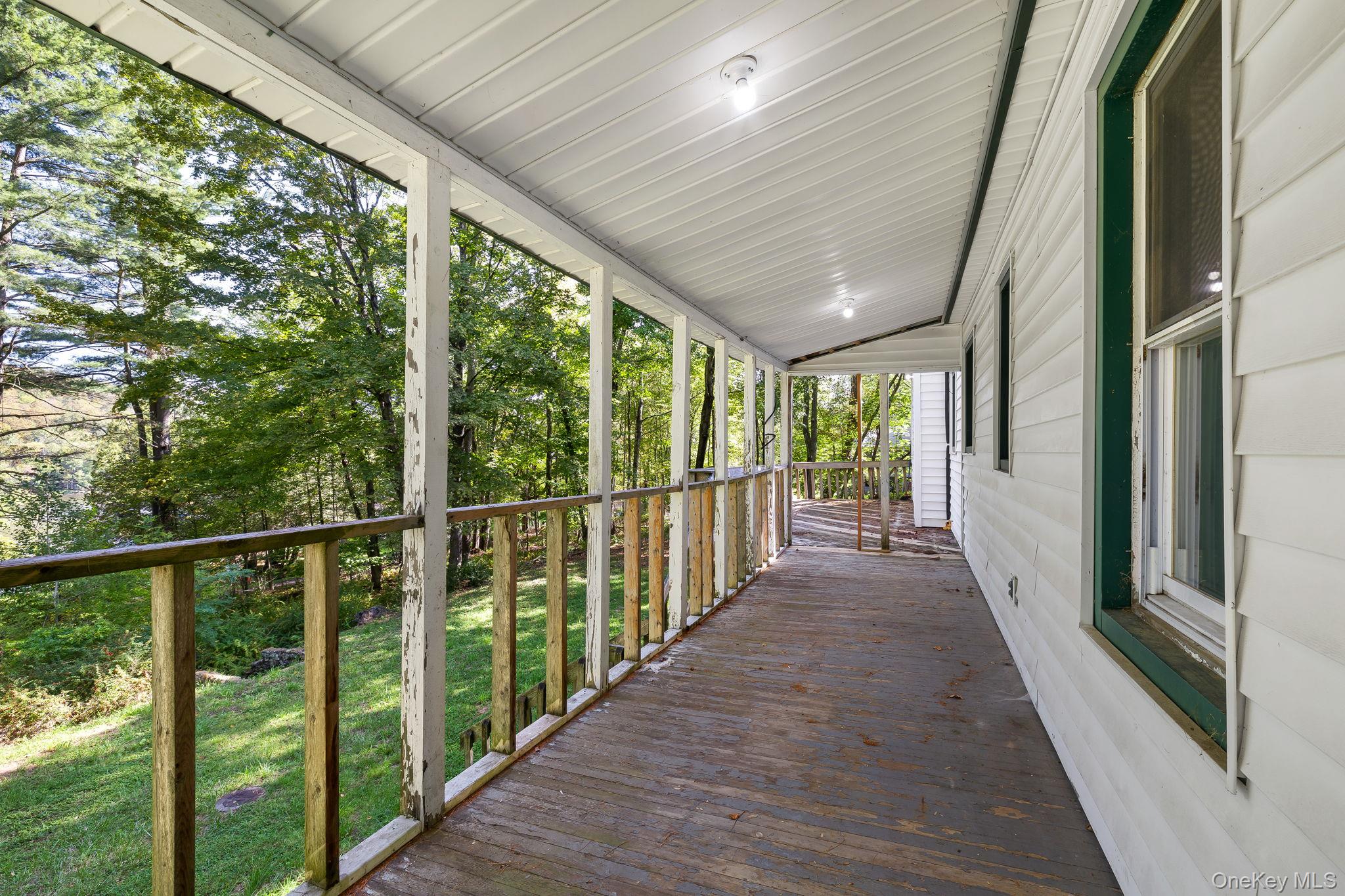 1463 Briscoe Road Swan Lake, NY 12783 - Photo 18 of 21 Wooden porch with a lawn