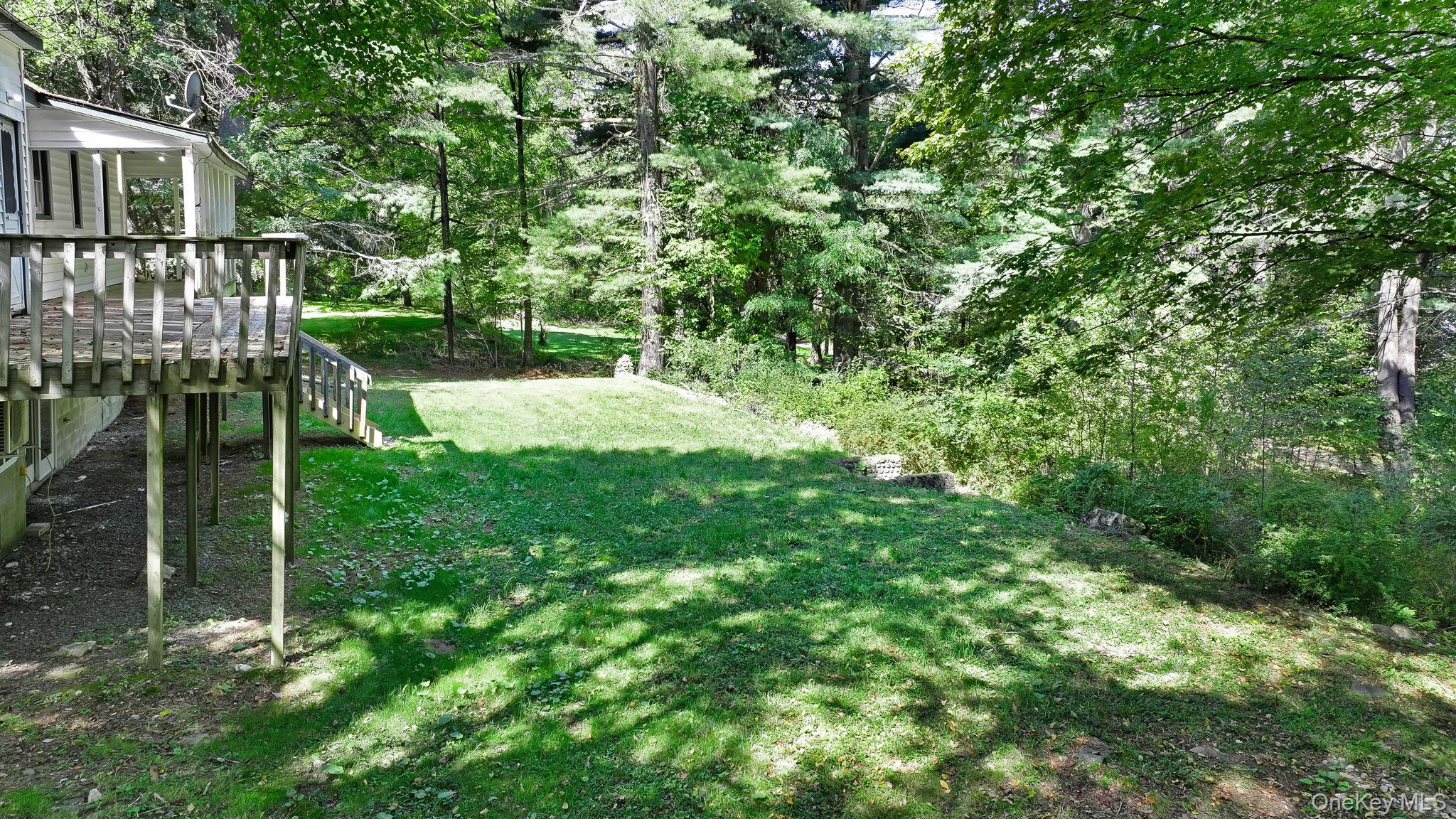1463 Briscoe Road Swan Lake, NY 12783 - Photo 21 of 21 View of green lawn featuring view of scattered trees