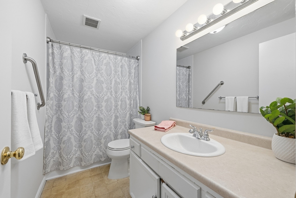 10 Mill Street, Unit Q Maynard, MA 01754 - Photo 13 of 31 a bathroom with a sink toilet and shower