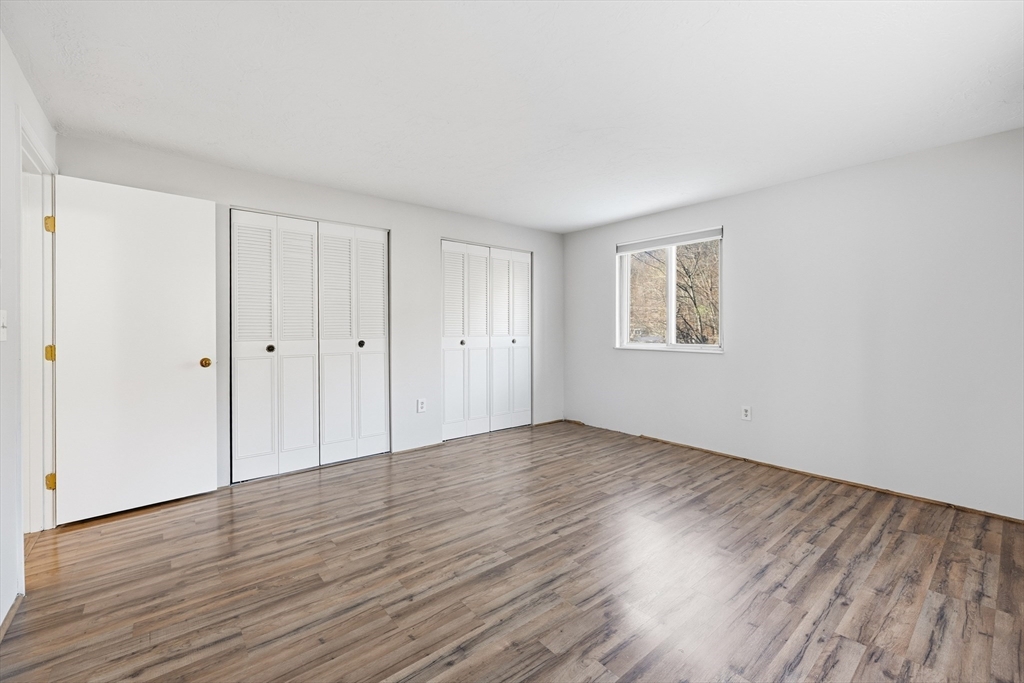 10 Mill Street, Unit Q Maynard, MA 01754 - Photo 18 of 31 a view of an empty room with wooden floor