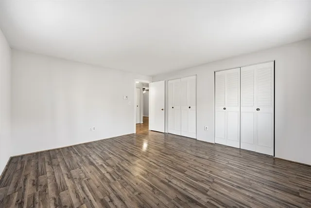a view of an empty room and wooden floor