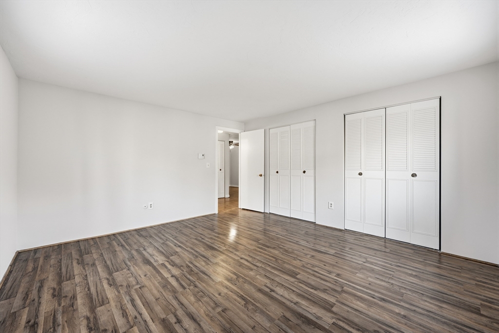 10 Mill Street, Unit Q Maynard, MA 01754 - Photo 19 of 31 a view of an empty room and wooden floor