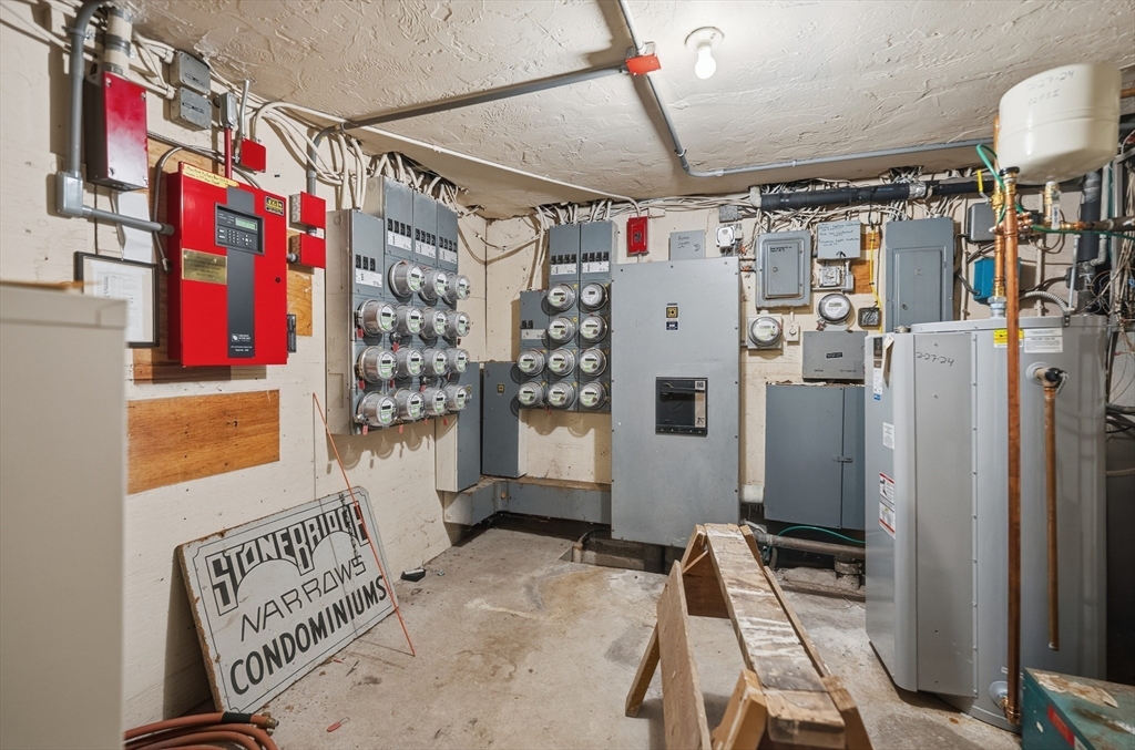 10 Mill Street, Unit Q Maynard, MA 01754 - Photo 23 of 31 a view of walk in closet with clothes and shoes