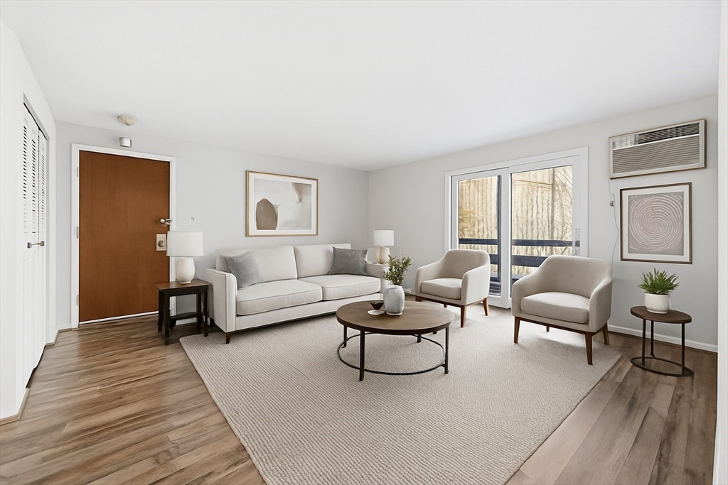 10 Mill Street, Unit Q Maynard, MA 01754 - Photo 3 of 31 a living room with furniture and a wooden floor