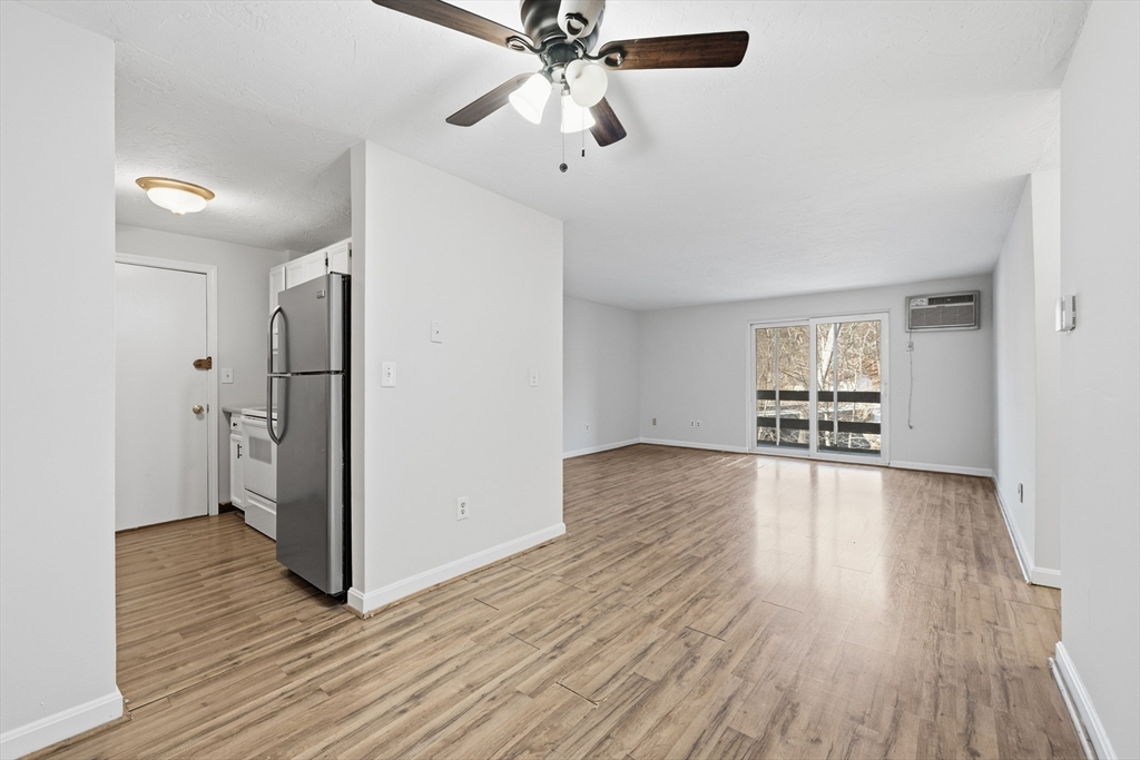 10 Mill Street, Unit Q Maynard, MA 01754 - Photo 9 of 31 wooden floor in an empty room with a window