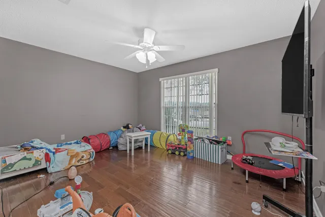 a living room with furniture and a wooden floor