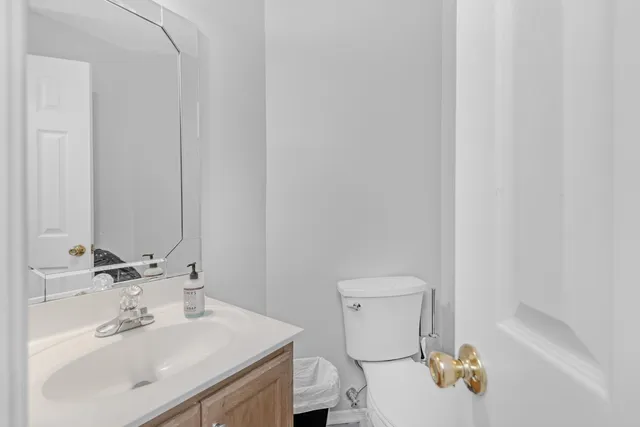 a bathroom with a sink toilet and a mirror