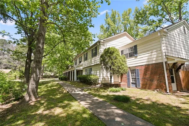 a view of a house with a tree in front of it