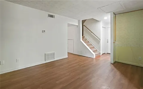 a view of an entryway with wooden floor