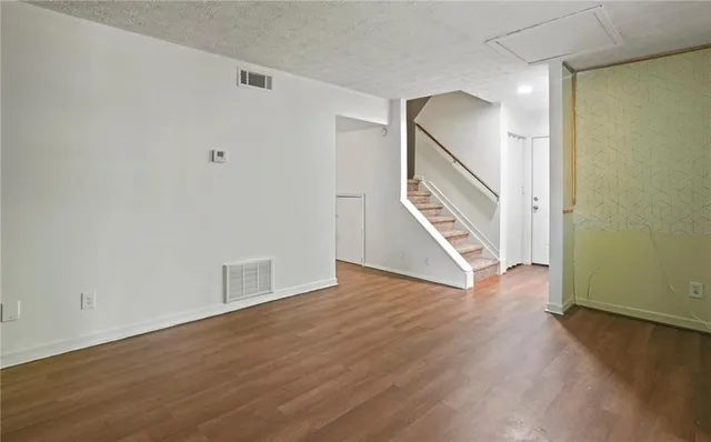 a view of an entryway with wooden floor
