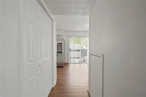 a view of a hallway with a wooden floor