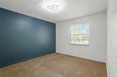 an empty room with a empty space and windows