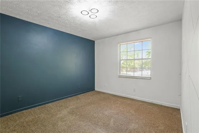 an empty room with a empty space and windows