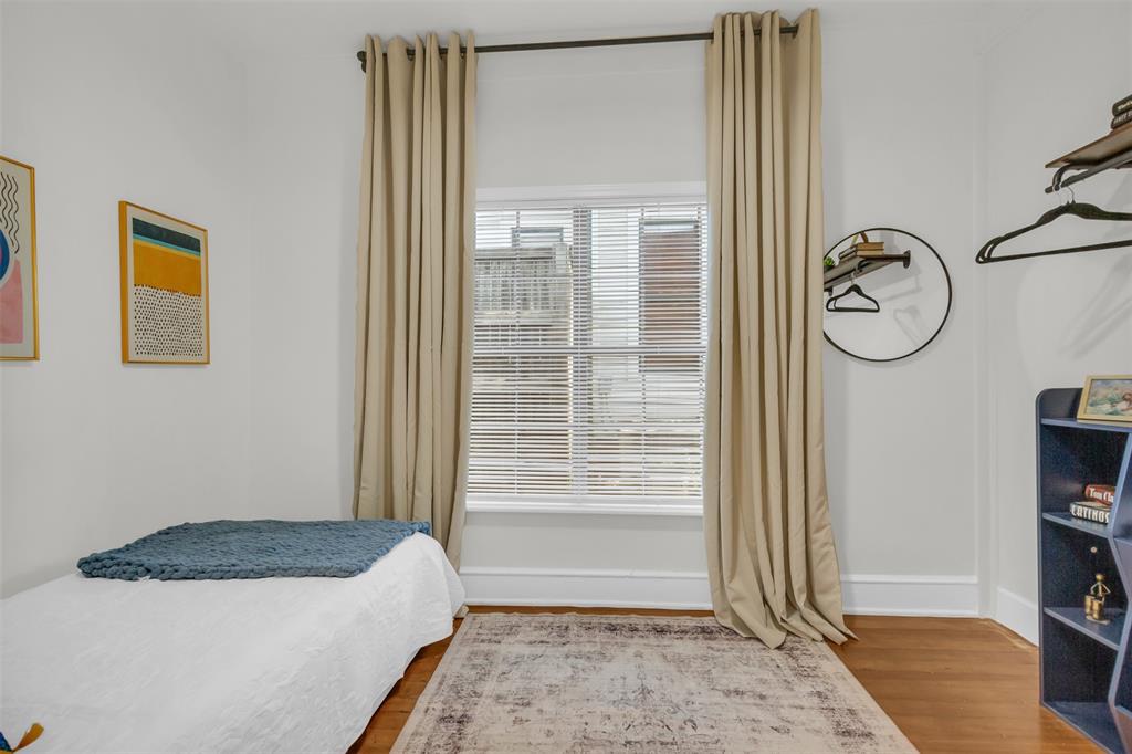 4121 Junius Street, Unit 4123 Dallas, TX 75246 - Photo 10 of 23 a bedroom with a bed and a window