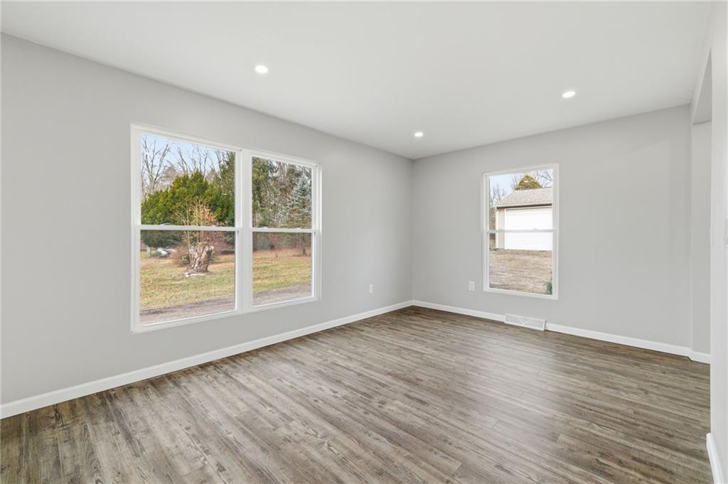 2104 Pulaski Road New Castle, PA 16105 - Photo 11 of 29 a view of an empty room with wooden floor and a window