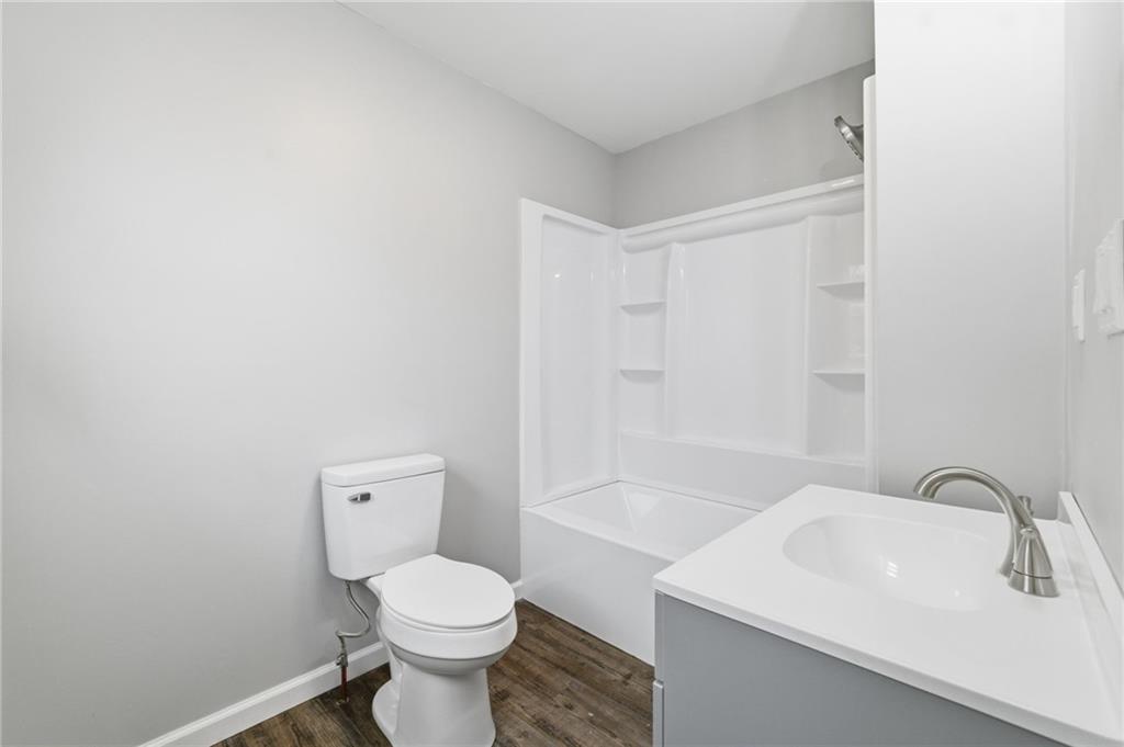 2104 Pulaski Road New Castle, PA 16105 - Photo 21 of 29 a bathroom with a sink a toilet and a mirror