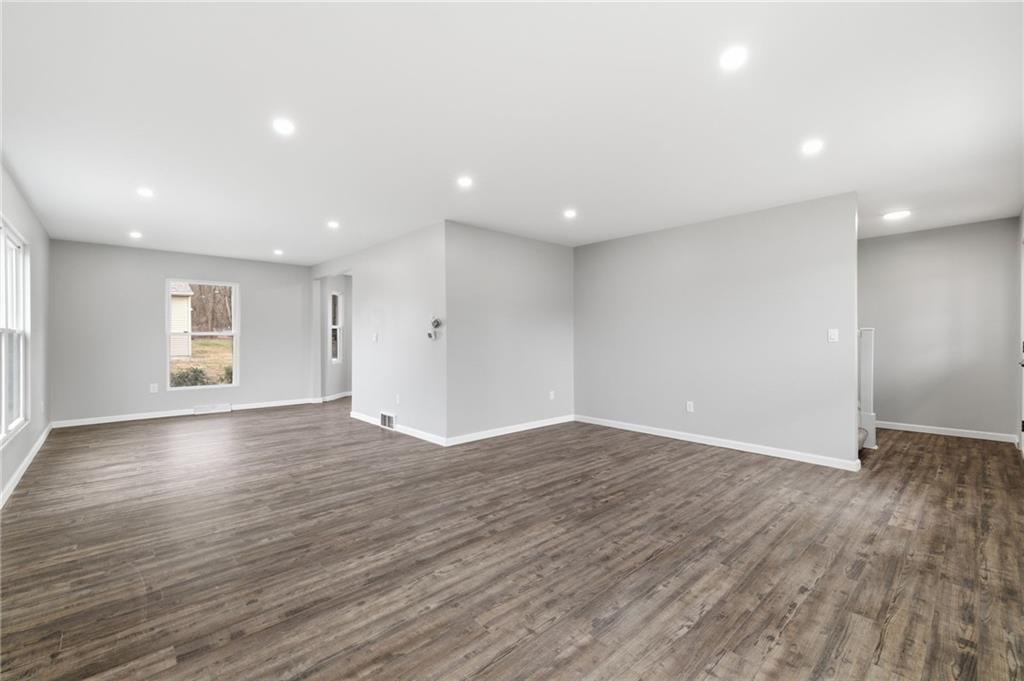 2104 Pulaski Road New Castle, PA 16105 - Photo 9 of 29 an empty room with wooden floor and windows