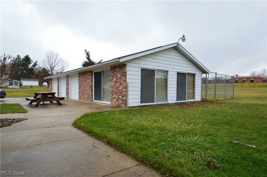1497 Saxe Road Mogadore, OH 44260 - Photo 25 of 26 Detached Garage with heated BONUS room. Large dog/animal pen stays with the home as well.